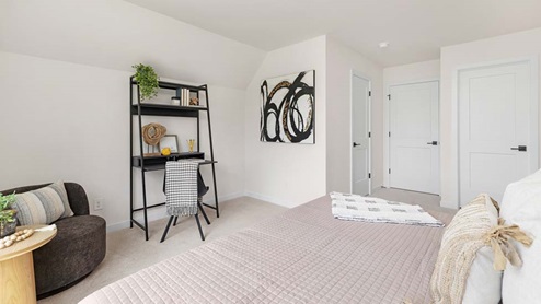 Carpeted bedroom with large windows
