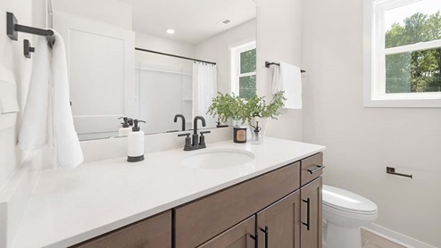 Bathroom with double sink vanity and bathtub shower combination