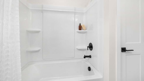 Bathroom with double sink vanity and bathtub shower combination