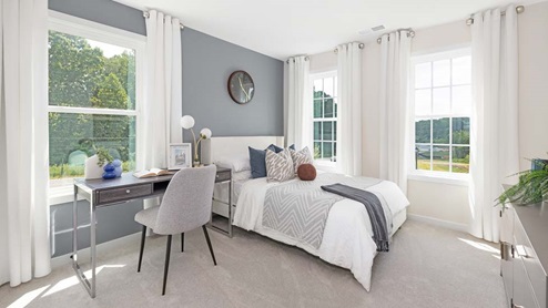 Carpeted bedroom with large windows