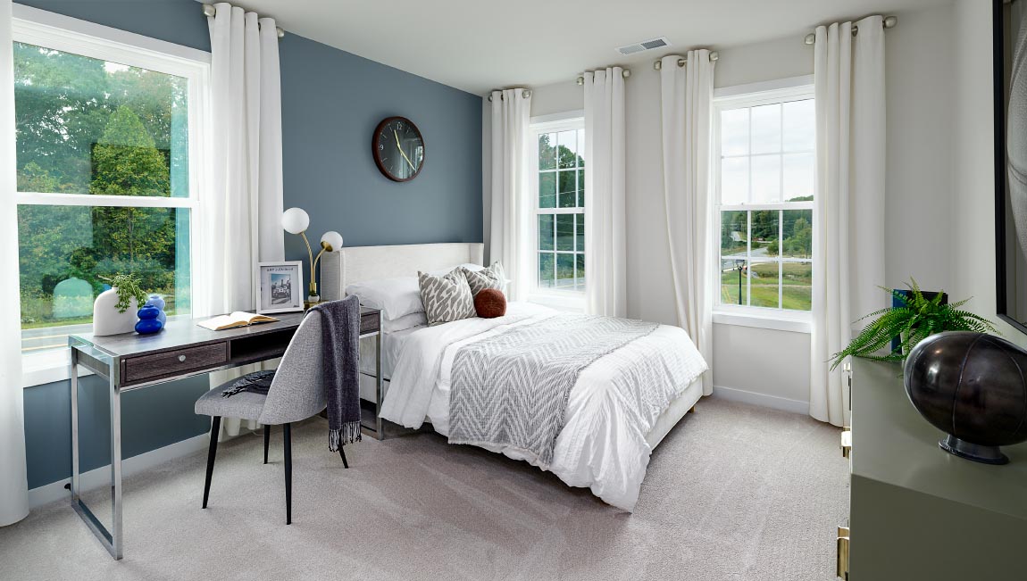 Carpeted bedroom with windows