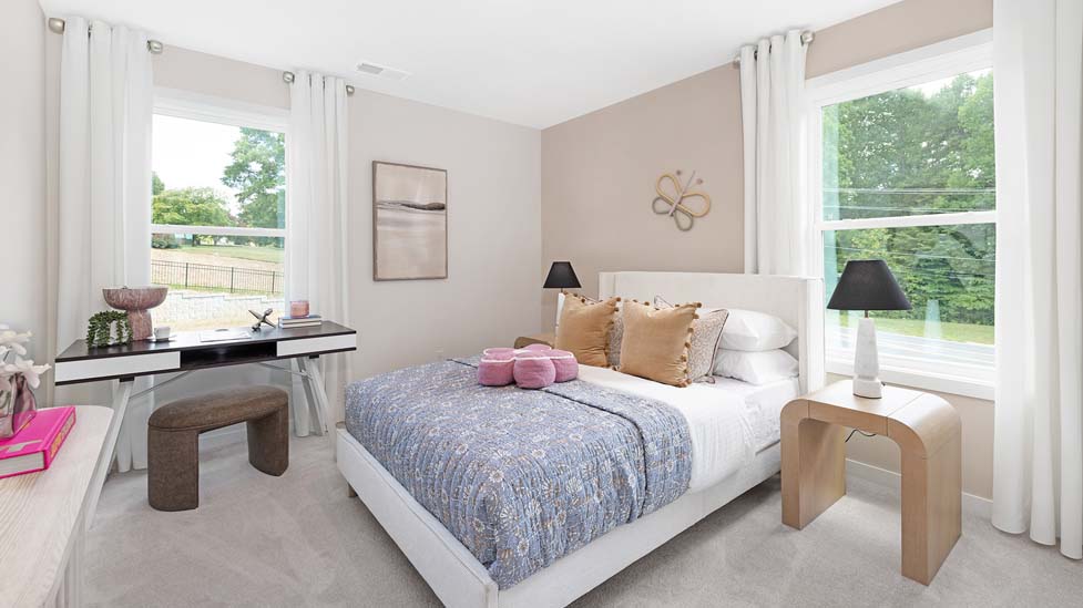 Carpeted bedroom with large windows