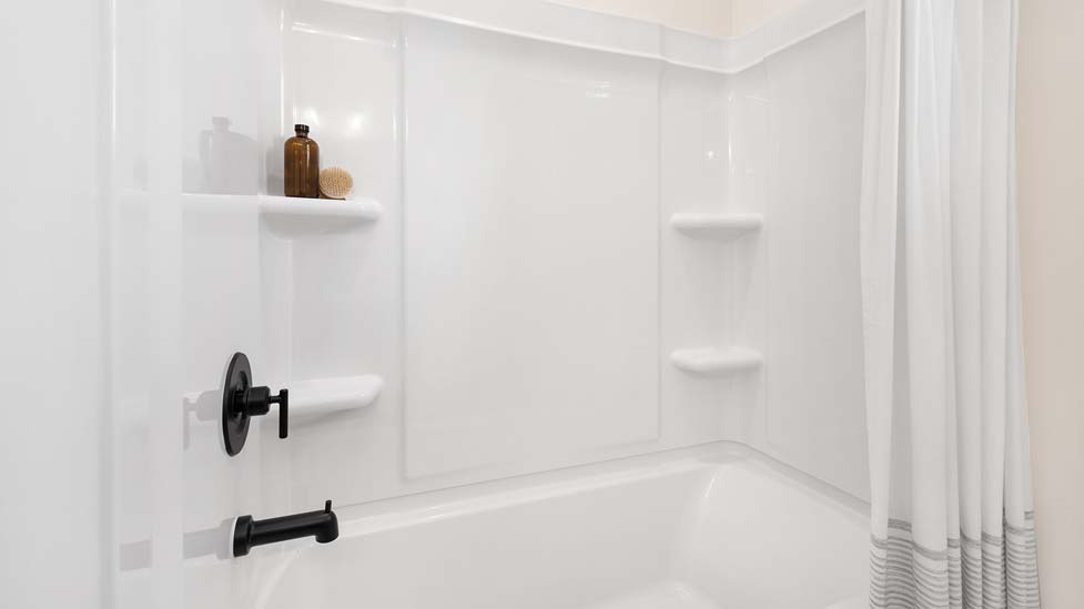 Bathroom with double sink vanity and bathtub shower combination