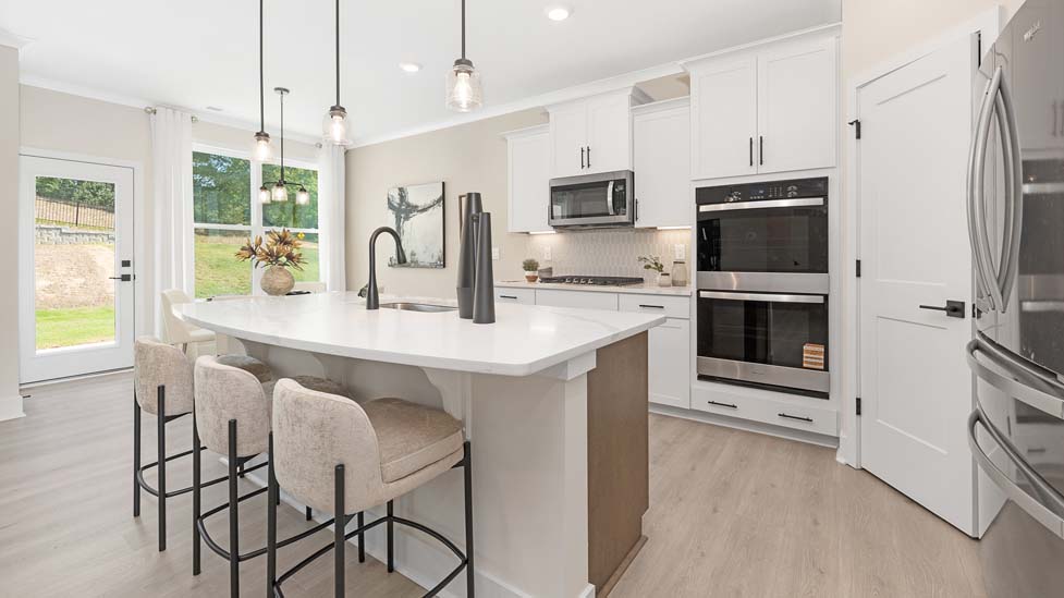 Kitchen and island with breakfast area and stainless steel appliances
