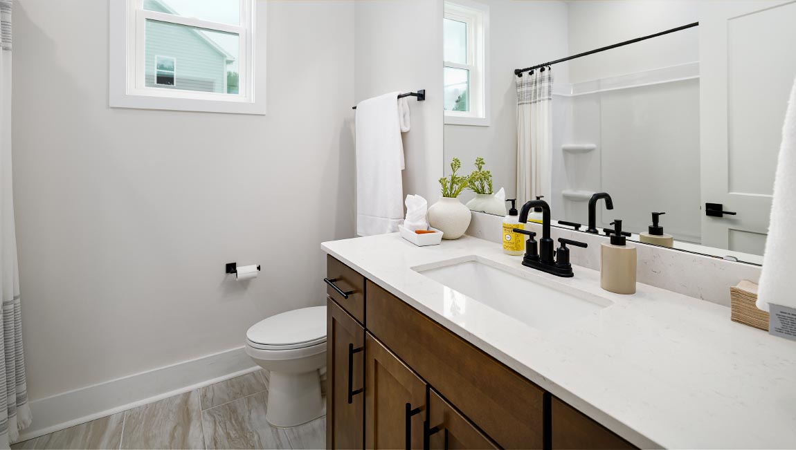 Bathroom with double sink vanity and bathtub shower combination