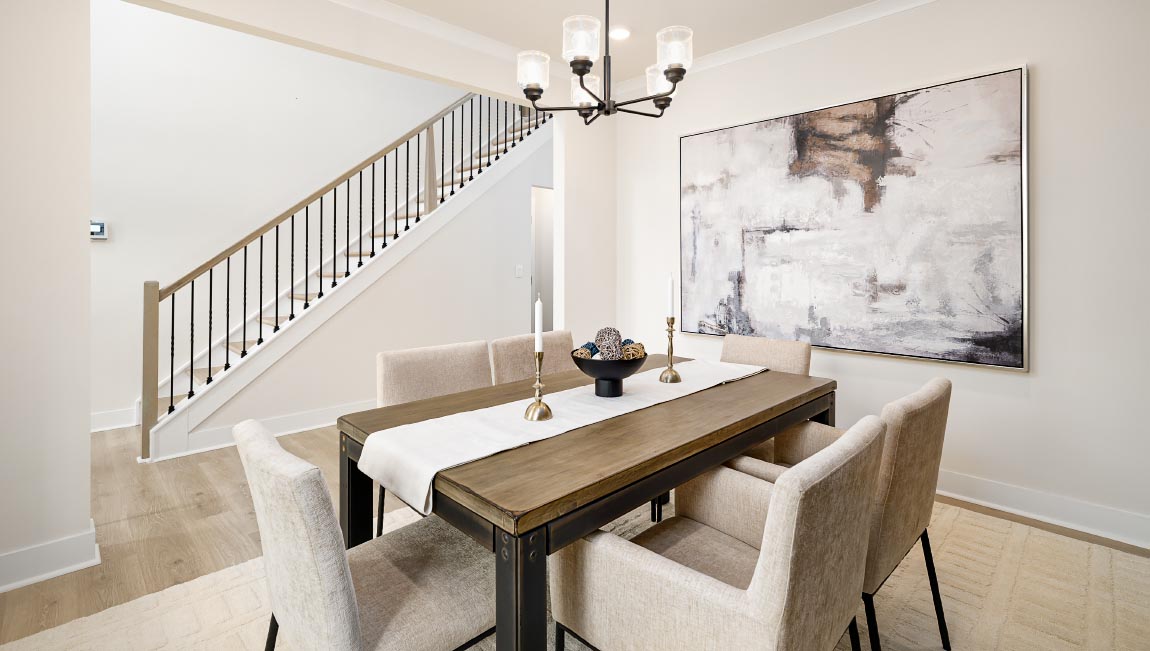 DIning area with hanging light and large windows