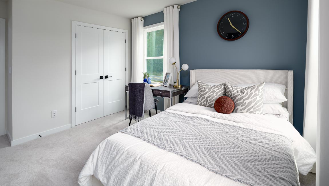 Carpeted bedroom with large windows