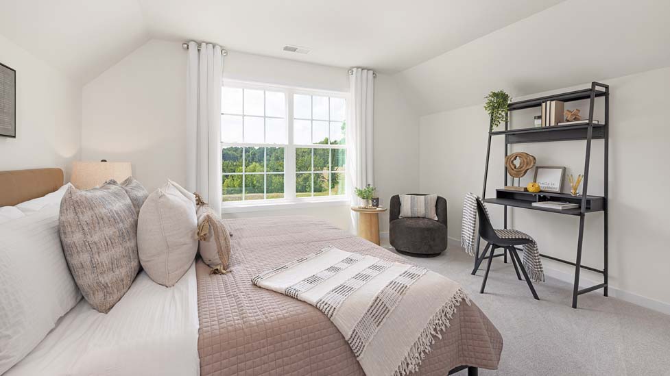 Carpeted bedroom with large windows