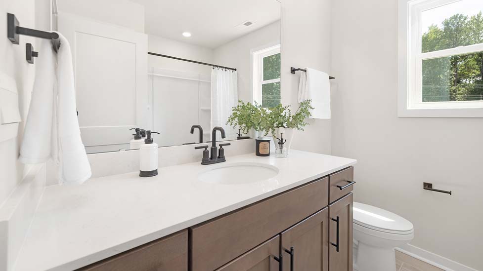 Bathroom with double sink vanity and bathtub shower combination