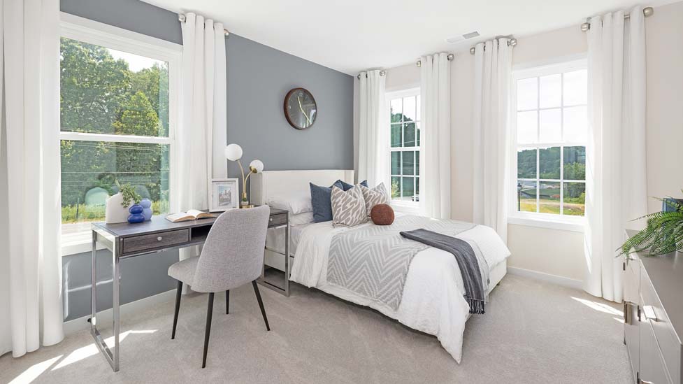 Carpeted bedroom with large windows