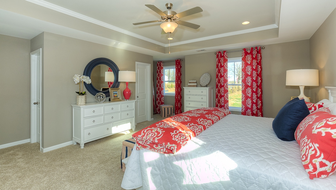 Primary bedroom with carpet and large windows