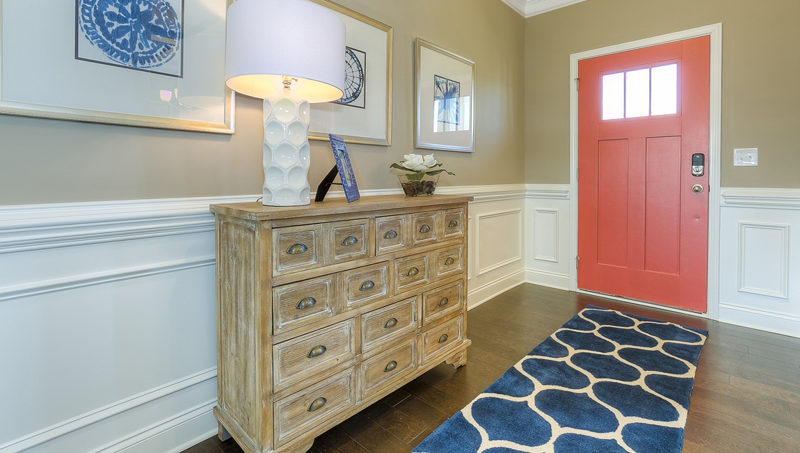 Welcoming foyer with staircase view and wood floors