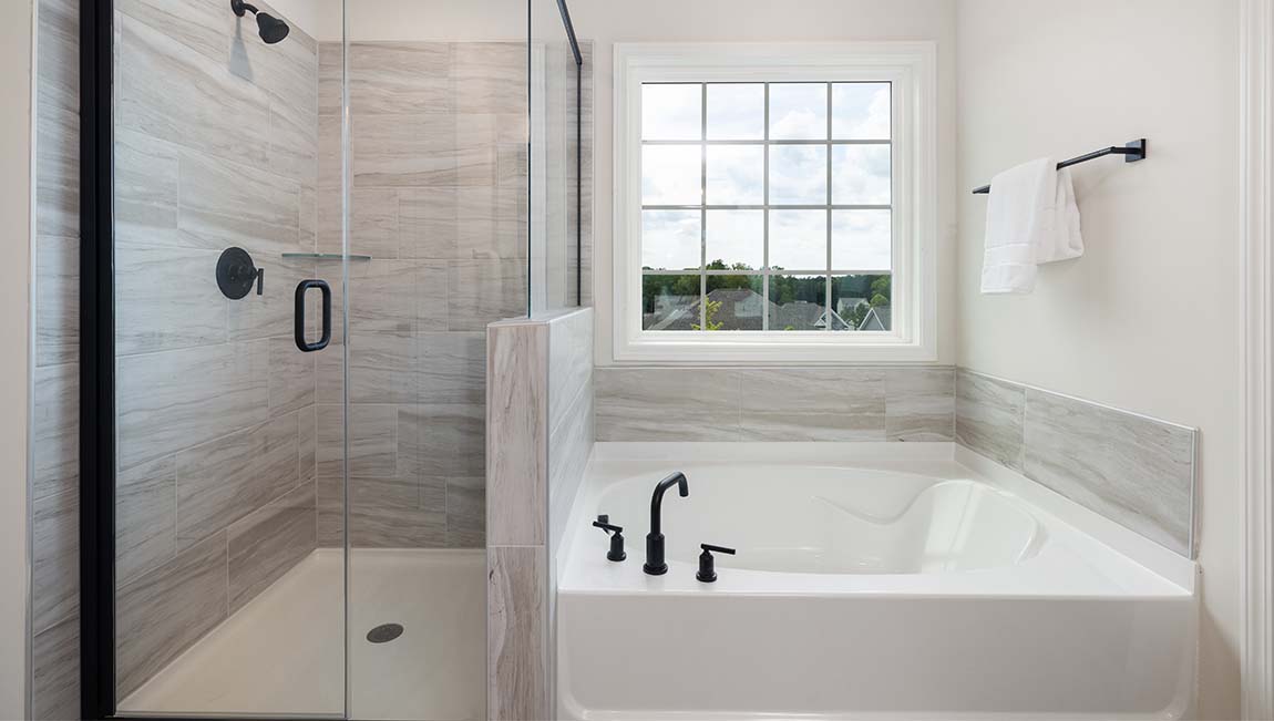 Bathroom with double sinks, white cabinets and counters