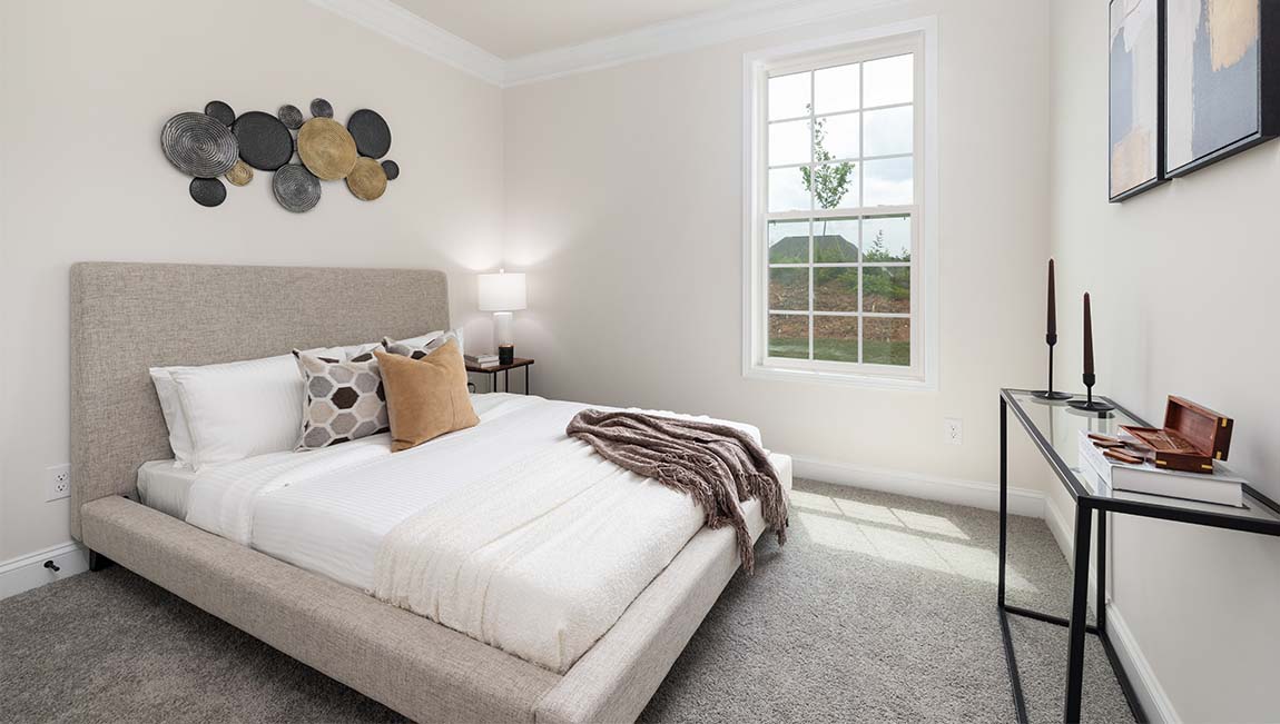 Carpeted bedroom with large window