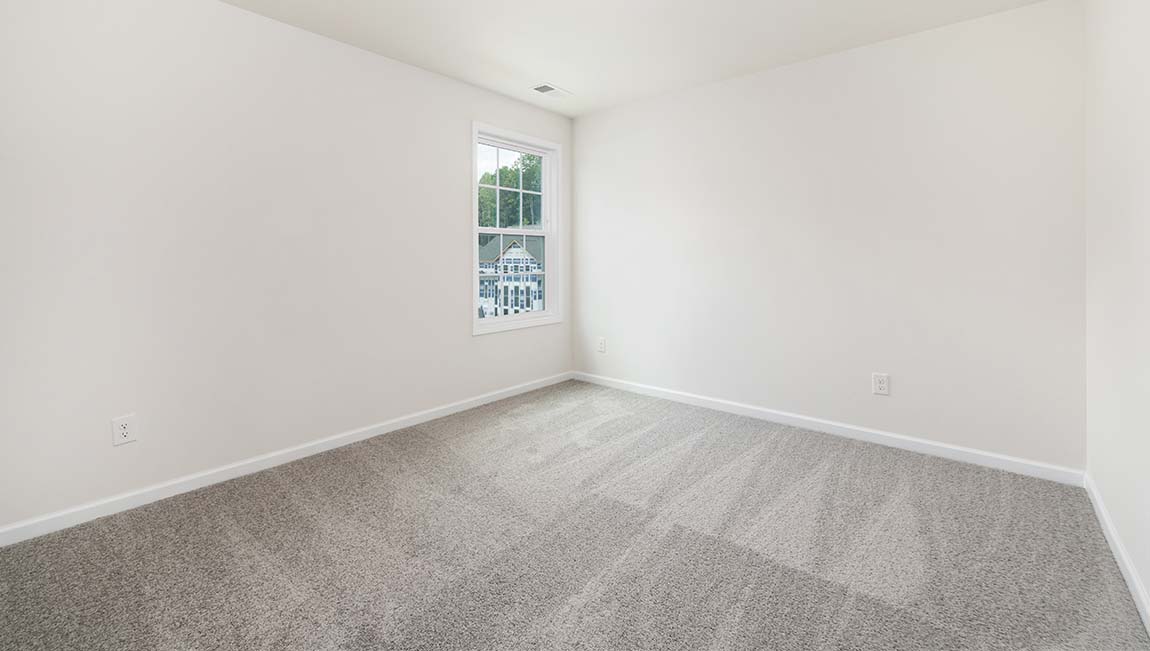 Carpeted bedroom with large window