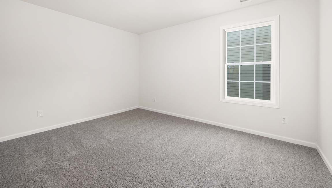 Carpeted bedroom with large window