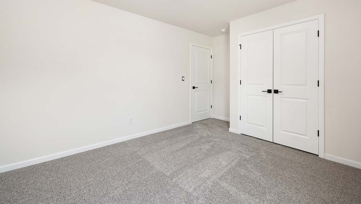 Carpeted bedroom with large window