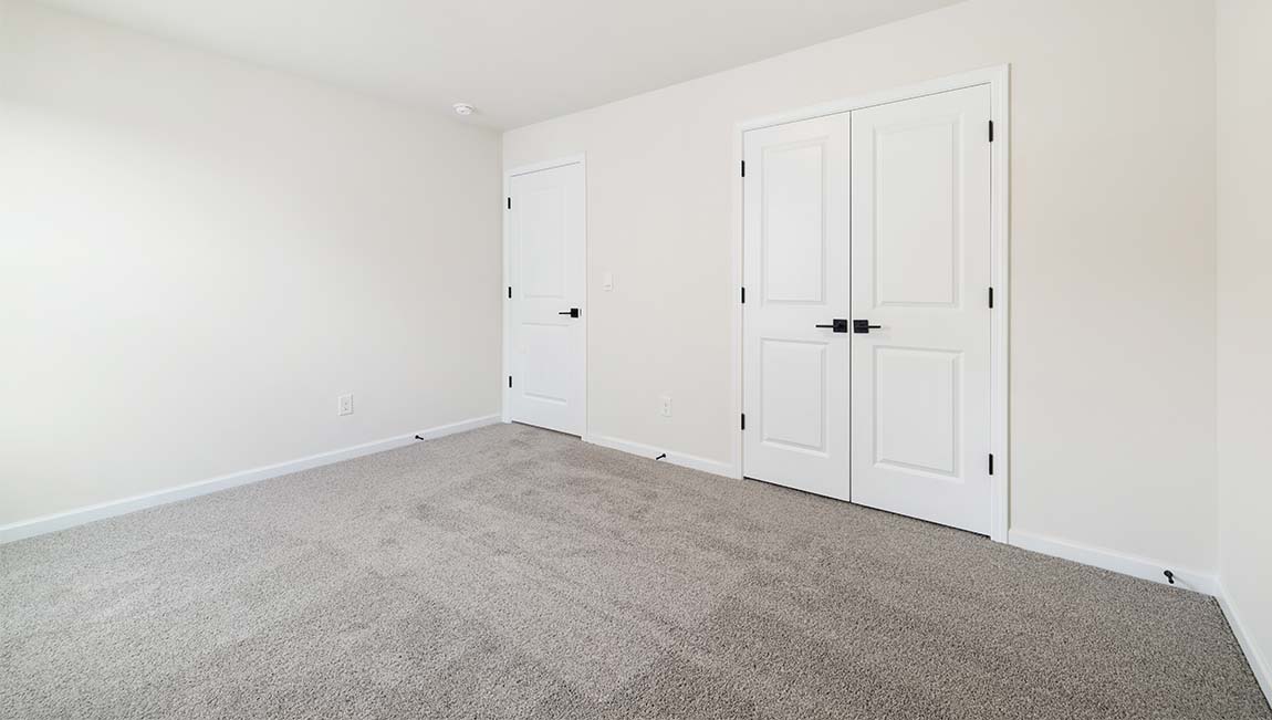 Carpeted bedroom with large window