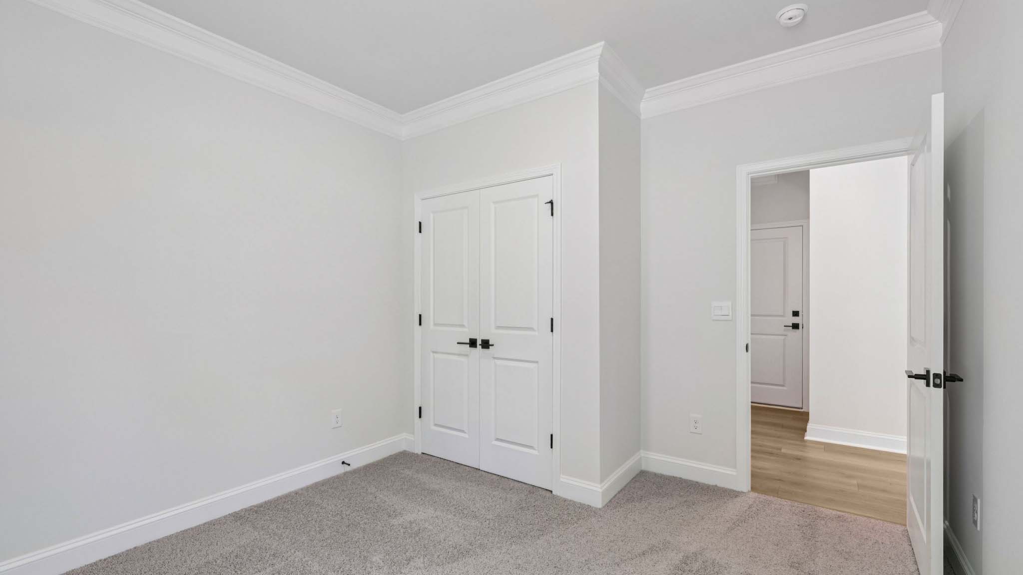 Carpeted bedroom with large window