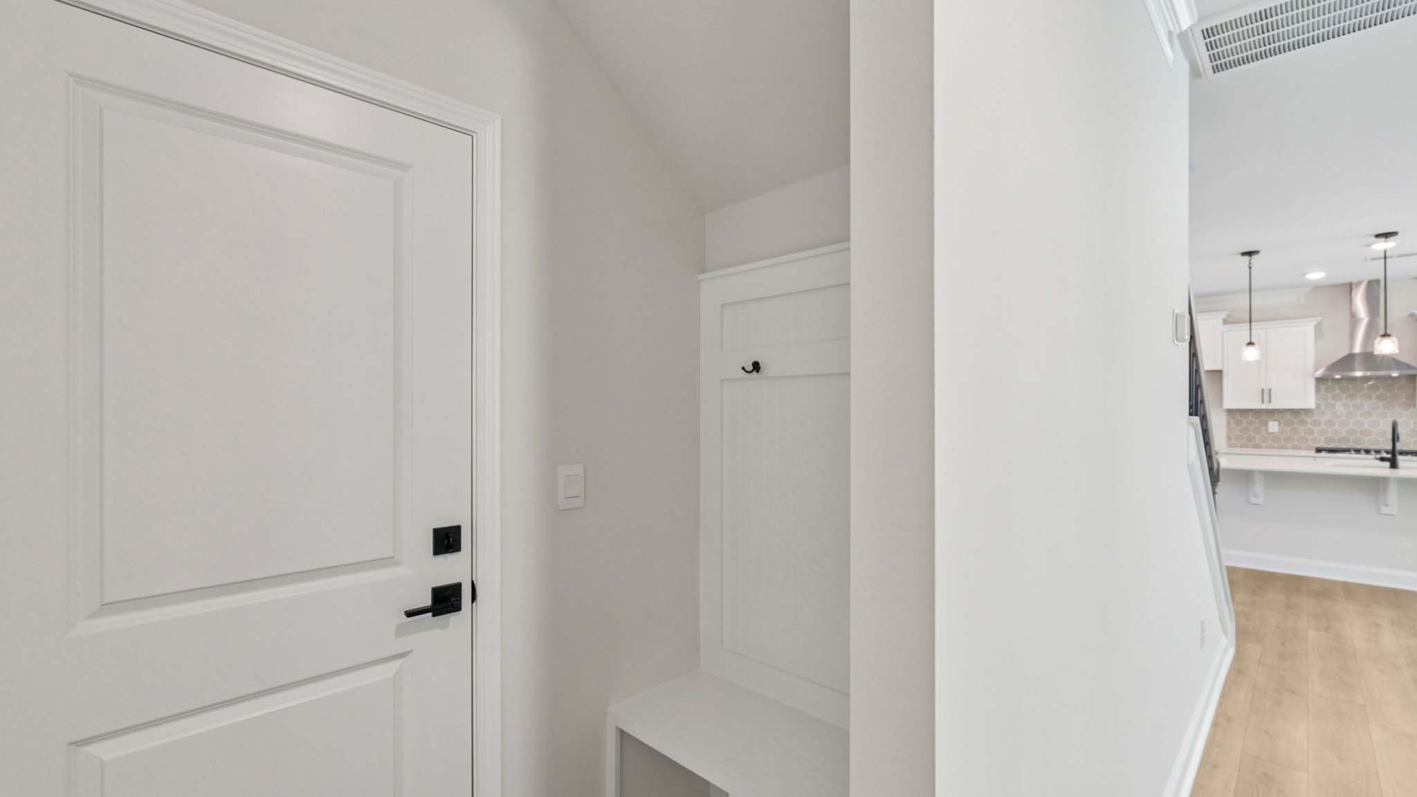 Upstairs hall, carpeted, with view of laundry room