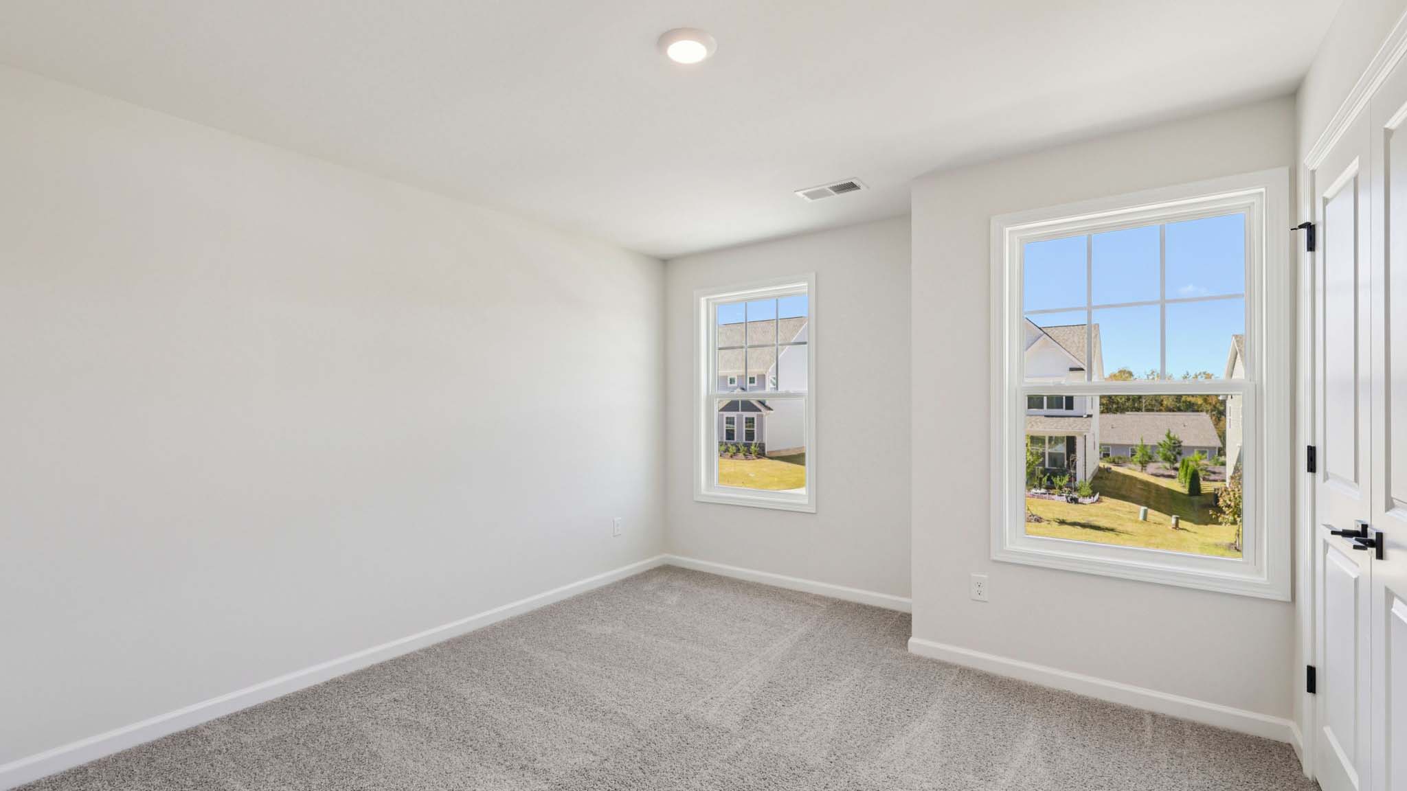 Carpeted bedroom with large window