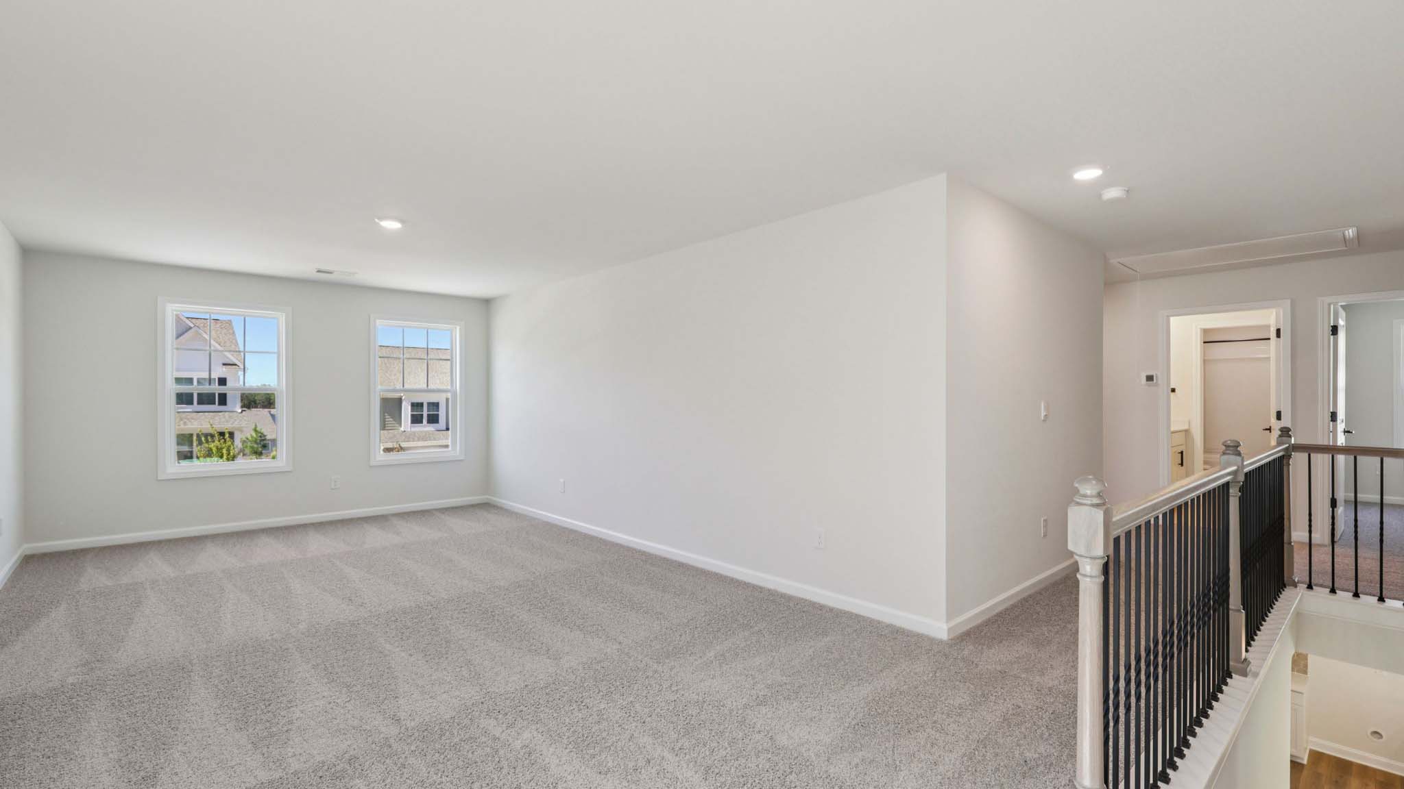 Upstairs hall, carpeted, with view of laundry room