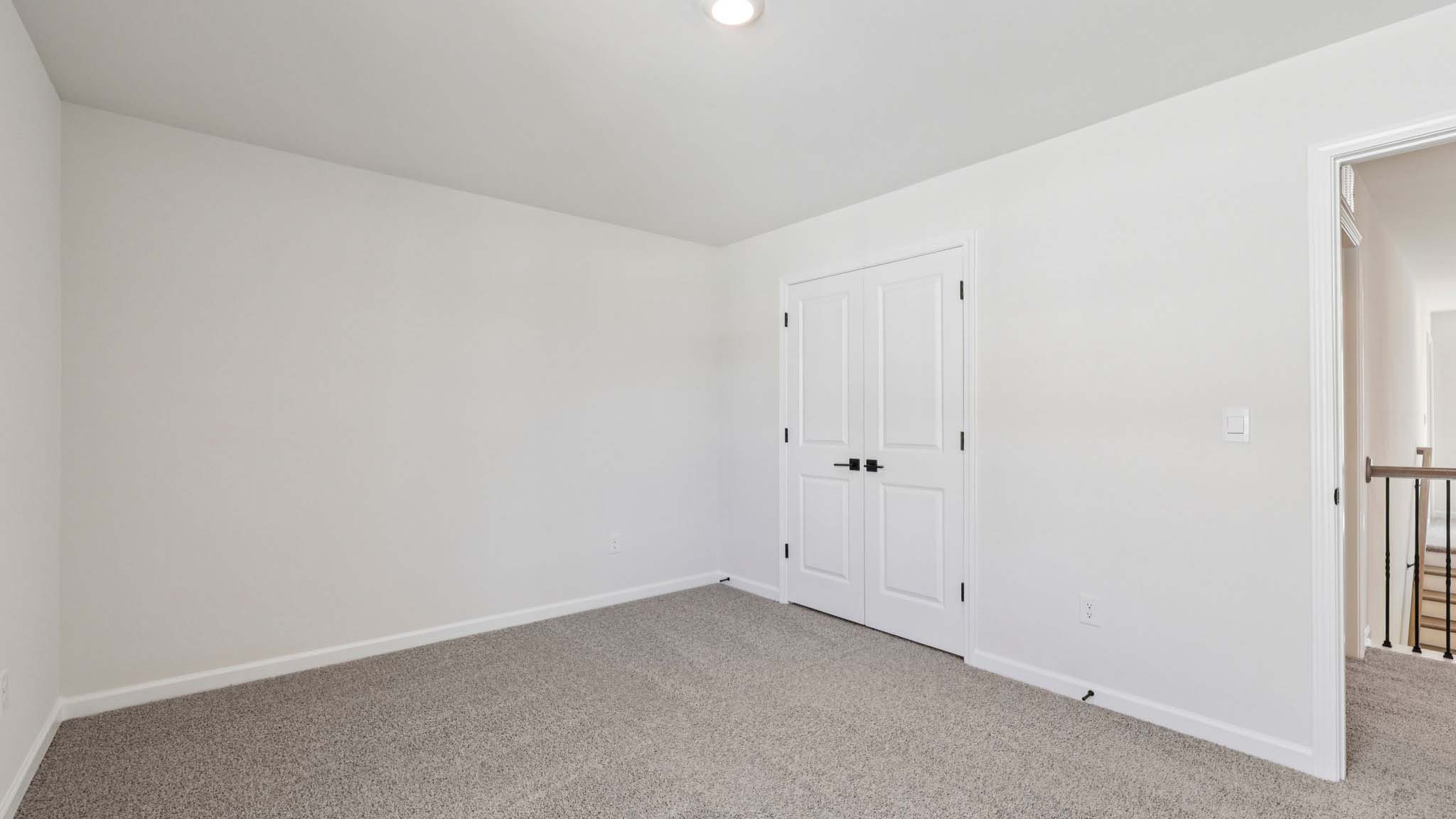 Carpeted bedroom with large window