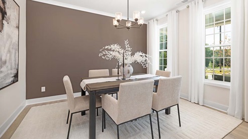 DIning area with hanging light and large windows