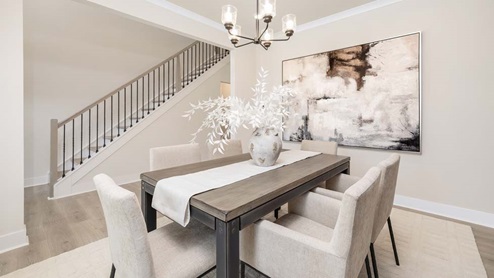 DIning area with hanging light and large windows