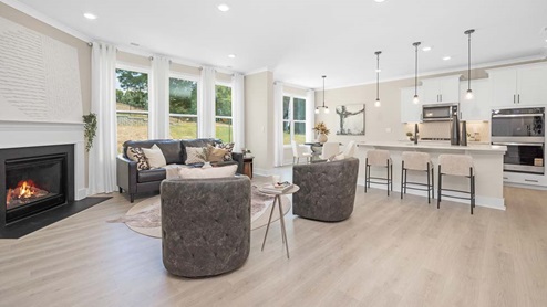 Open concept Living room area with large windows and fireplace