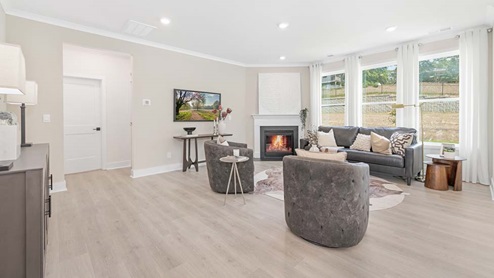 Open concept Living room area with large windows and fireplace