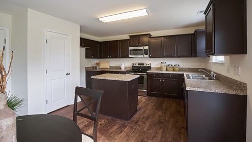 Kitchen with island, brown cabinets