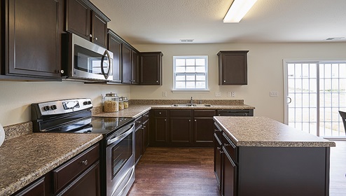 Kitchen with island, brown cabinets