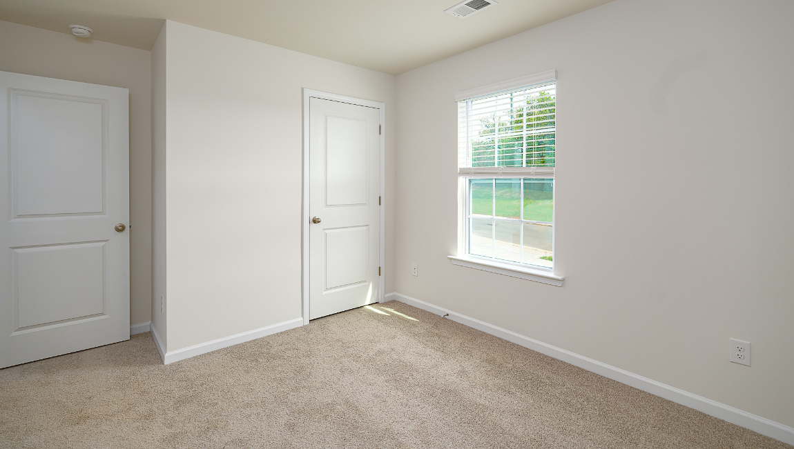 Carpeted bedroom with large window