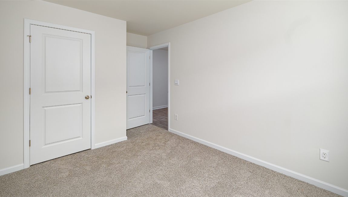 Carpeted bedroom with large window