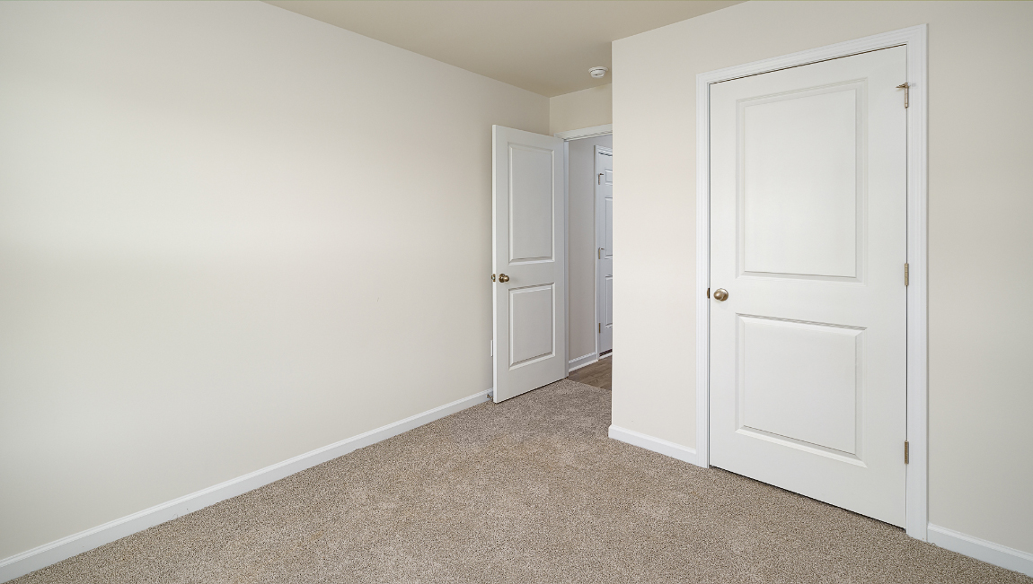 Carpeted bedroom with large window