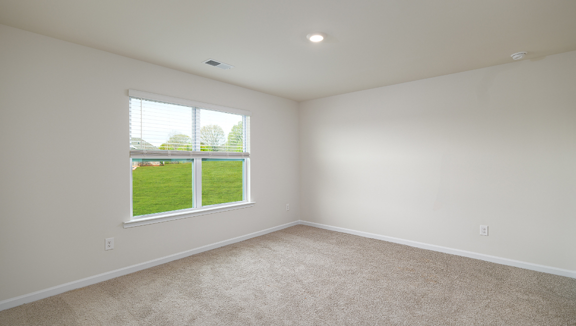 Carpeted bedroom with large window