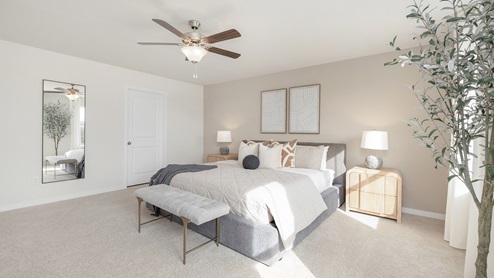 Primary bedroom with carpet, large windows and ceiling fan. new homes in charlotte, nc
