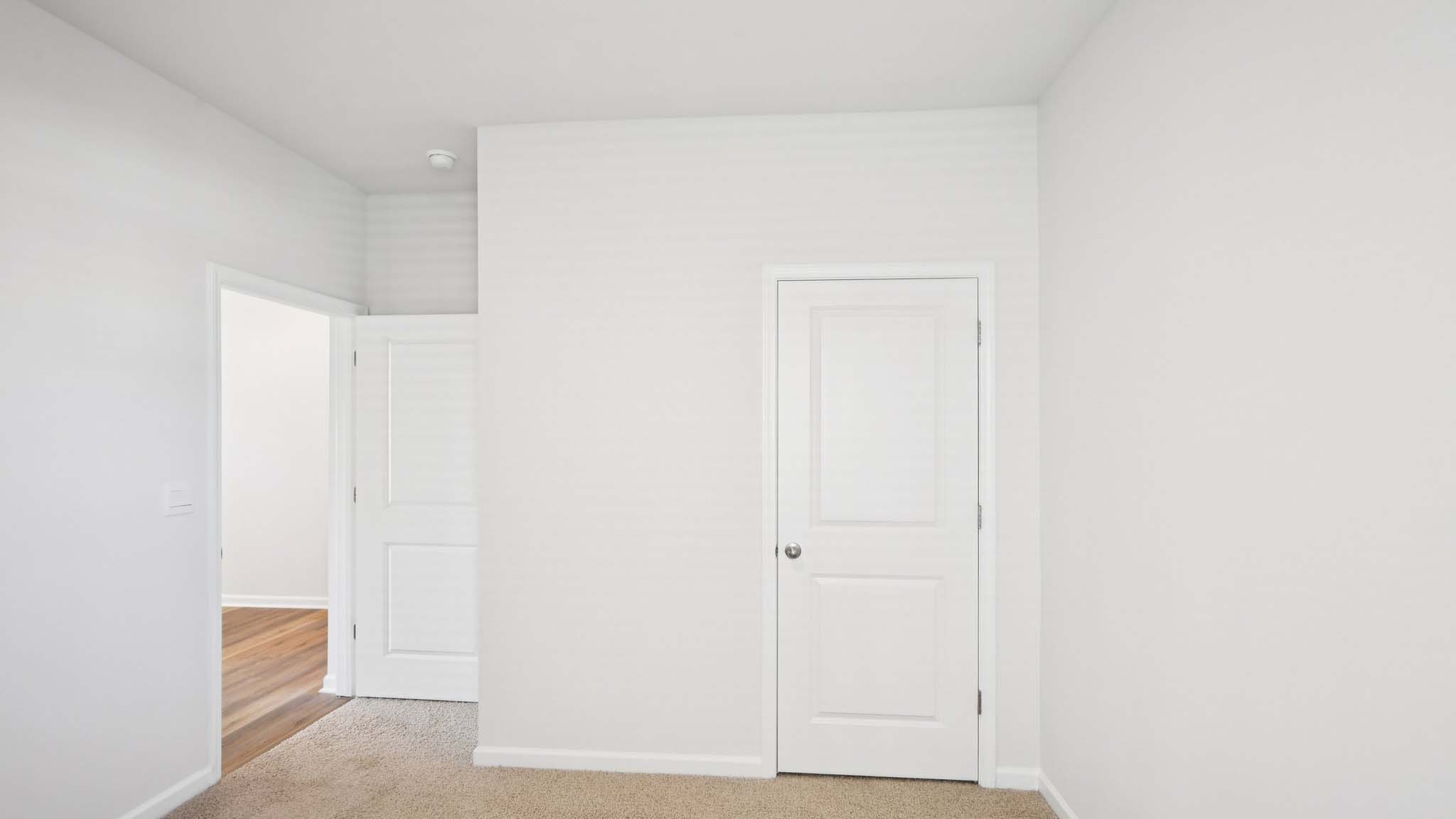 Carpeted bedroom with large window