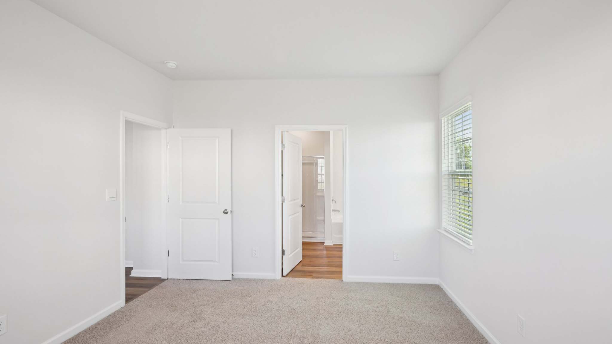 Primary bedroom with large windows