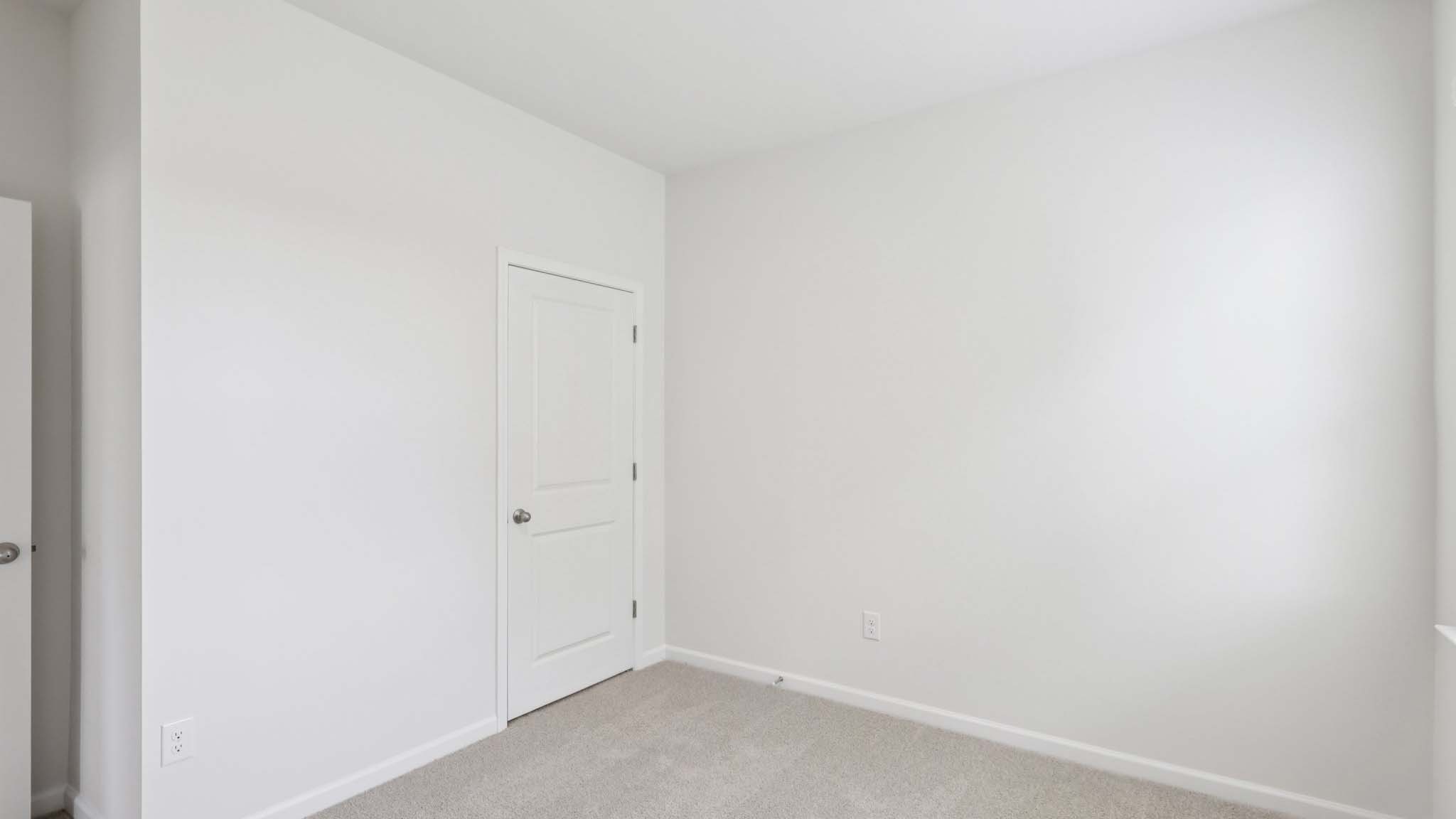 Carpeted bedroom with large window