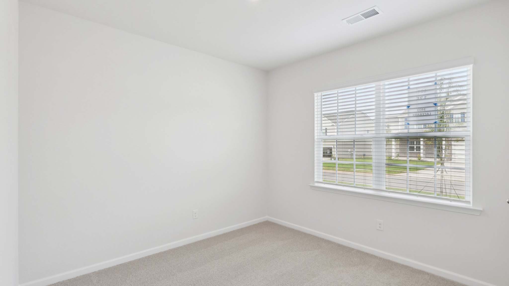 Primary bedroom with large windows