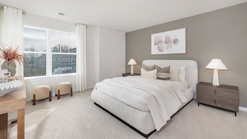 carpeted bedroom with large windows. new homes in charlotte, nc