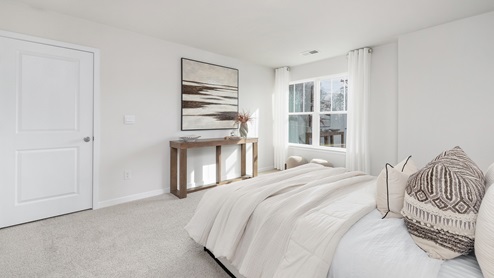 carpeted bedroom with large windows. new homes in charlotte, nc