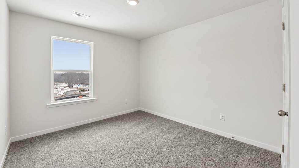 Carpeted bedroom with large window