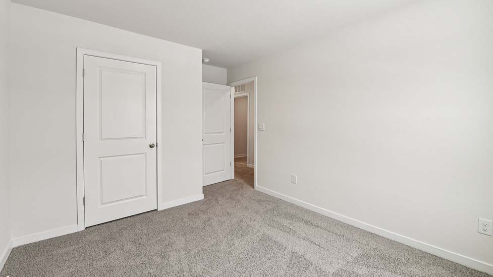 Carpeted bedroom with large window
