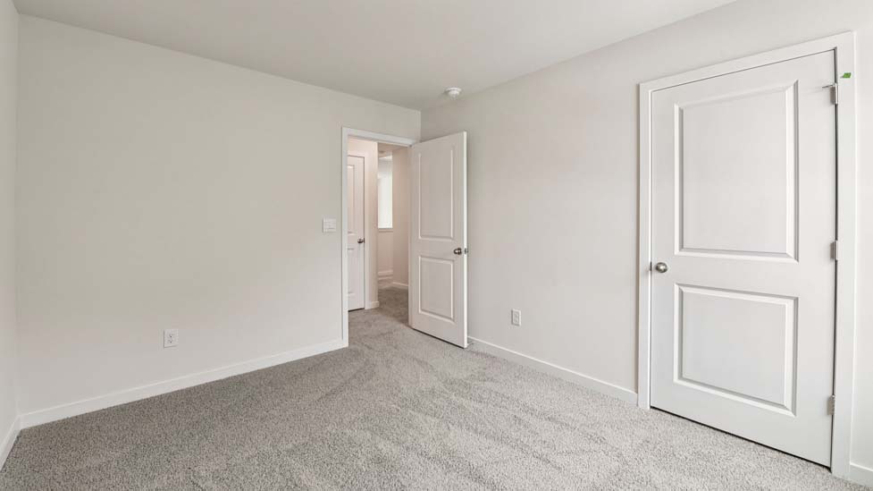 Carpeted bedroom with large window