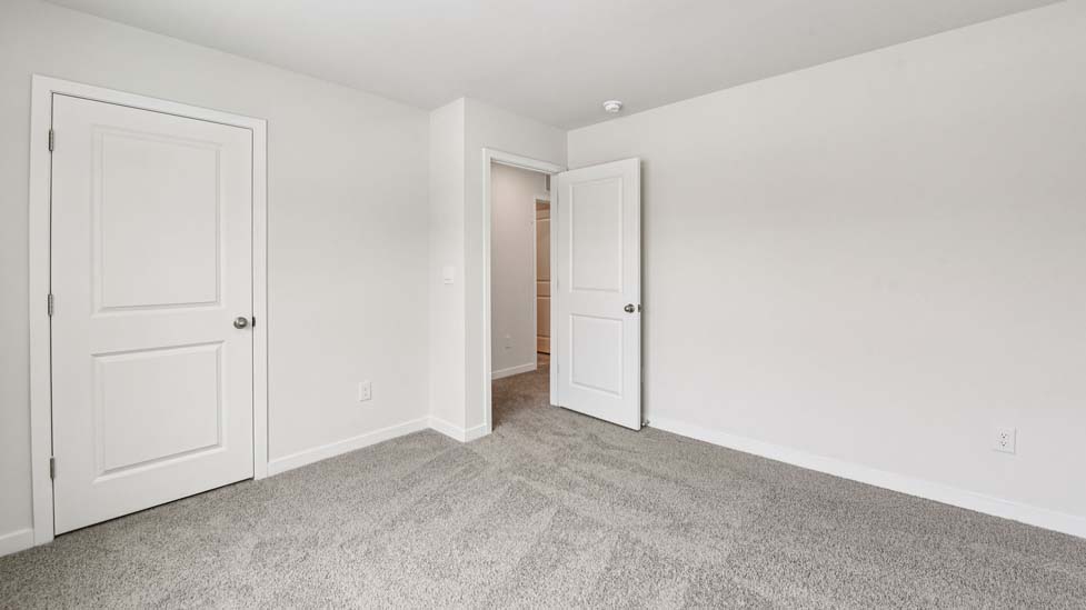 Carpeted bedroom with large window