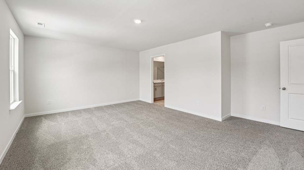 Carpeted bedroom with large window