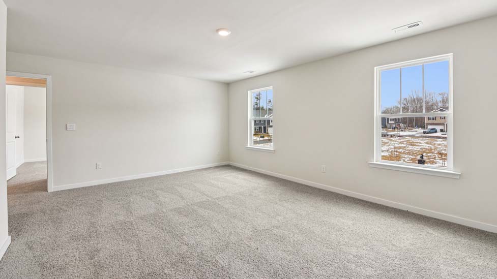 Carpeted bedroom with large window